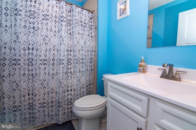 bathroom featuring toilet, a shower with curtain, and vanity