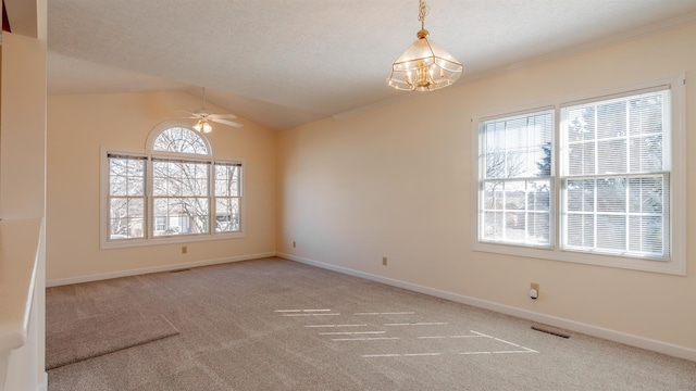 spare room featuring baseboards, carpet, vaulted ceiling, a textured ceiling, and ceiling fan with notable chandelier