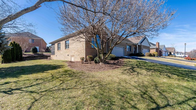 ranch-style home featuring an attached garage, a residential view, a front lawn, and brick siding