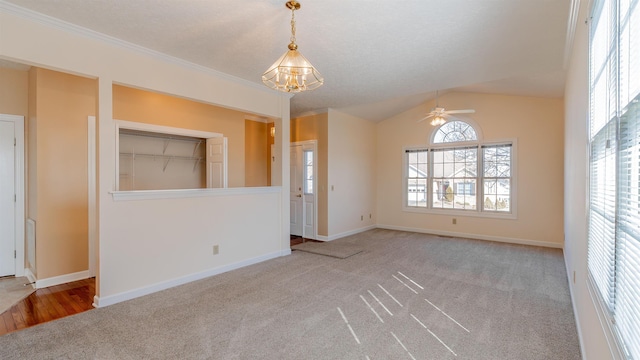 spare room featuring lofted ceiling, baseboards, and carpet flooring