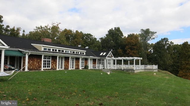 rear view of house featuring a yard