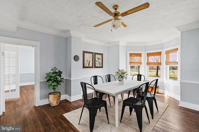 dining area with a textured ceiling, crown molding, and hardwood / wood-style floors