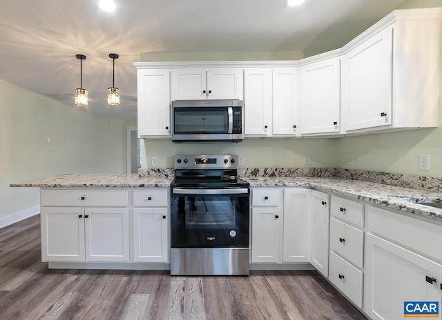 kitchen featuring hanging light fixtures, white cabinetry, appliances with stainless steel finishes, and hardwood / wood-style floors