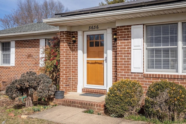 property entrance with brick siding