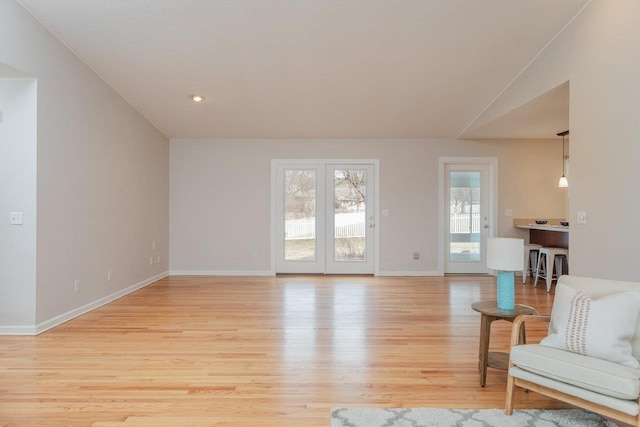 living room featuring light wood finished floors and baseboards