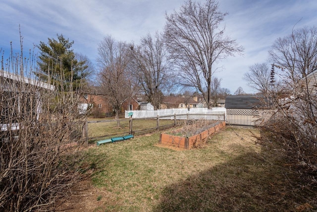 view of yard featuring a vegetable garden and fence