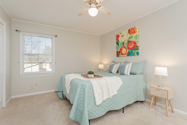 carpeted bedroom featuring baseboards and ceiling fan