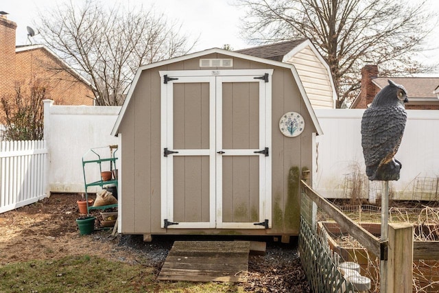 view of shed featuring fence