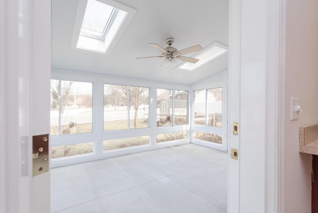 unfurnished sunroom featuring vaulted ceiling with skylight and ceiling fan