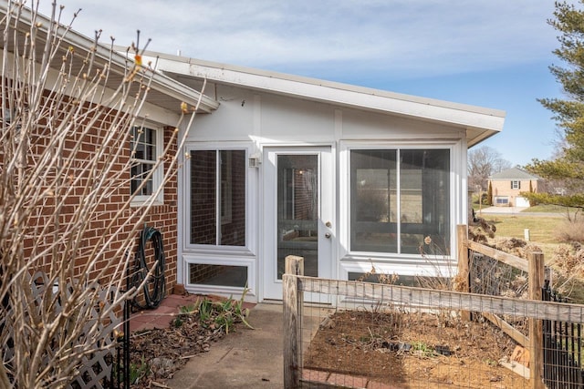 property entrance featuring brick siding