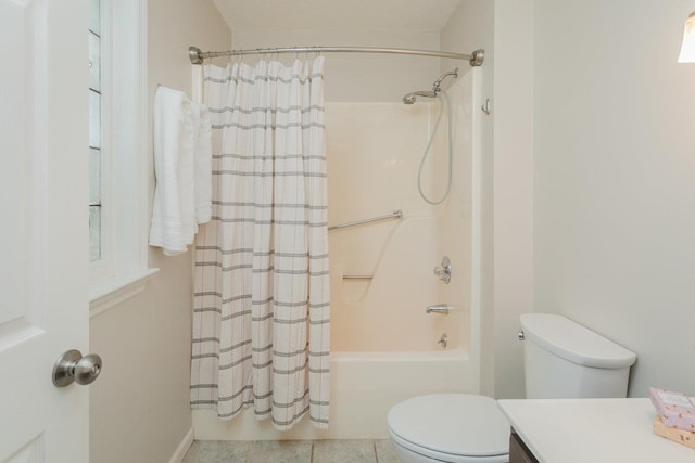 full bath with tile patterned floors, toilet, vanity, and shower / bath combo