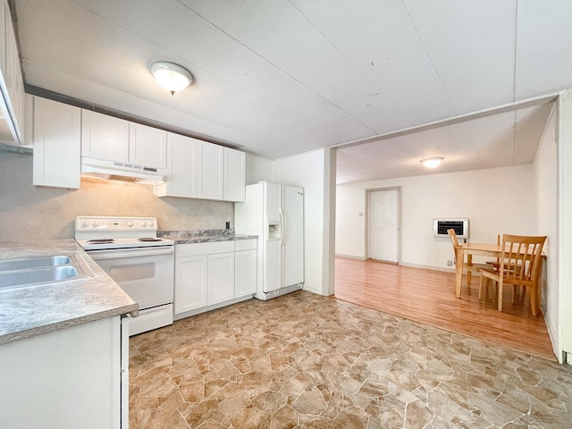 kitchen featuring white cabinetry, white appliances, sink, and heating unit