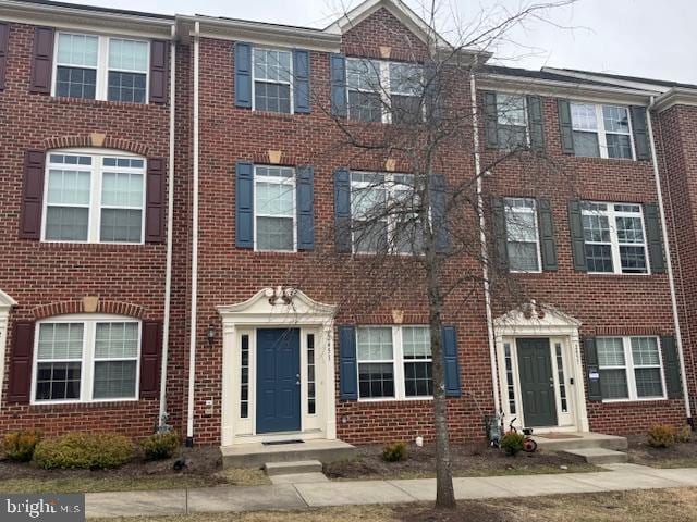 townhome / multi-family property featuring brick siding