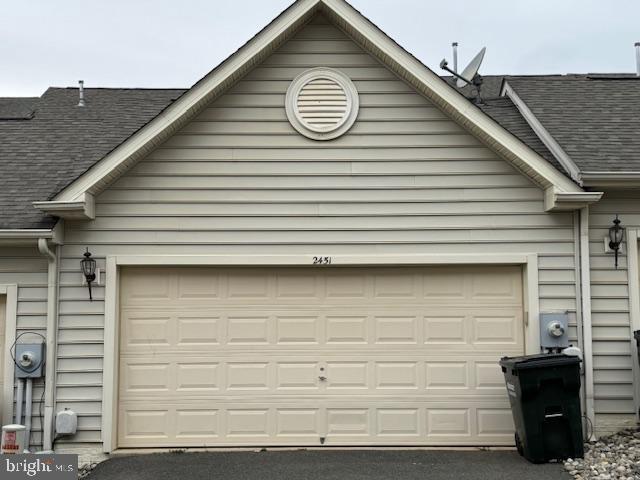 garage featuring aphalt driveway