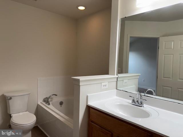 bathroom with vanity, toilet, a bath, and recessed lighting