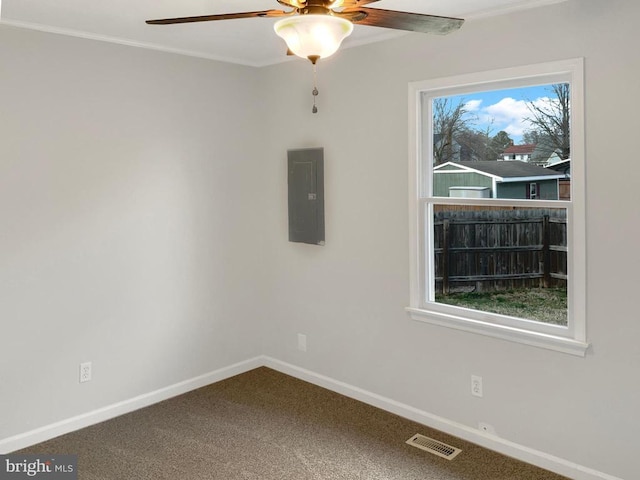 carpeted empty room with crown molding, electric panel, and ceiling fan