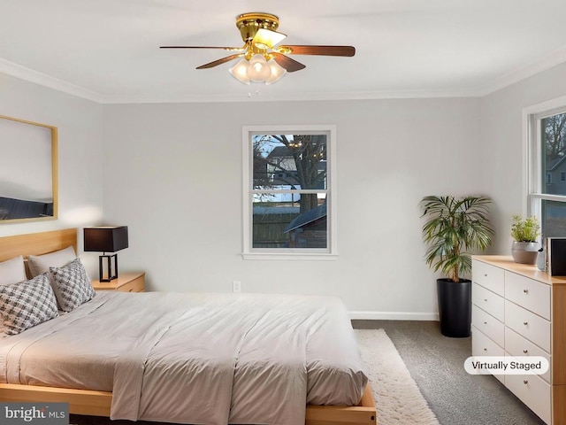 carpeted bedroom with crown molding, baseboards, and ceiling fan