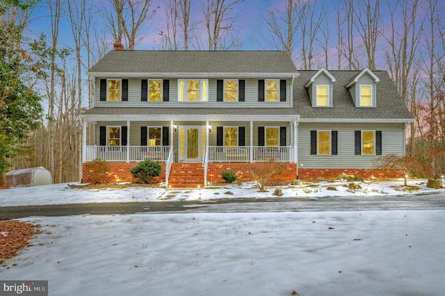 view of front of property featuring a porch and roof with shingles