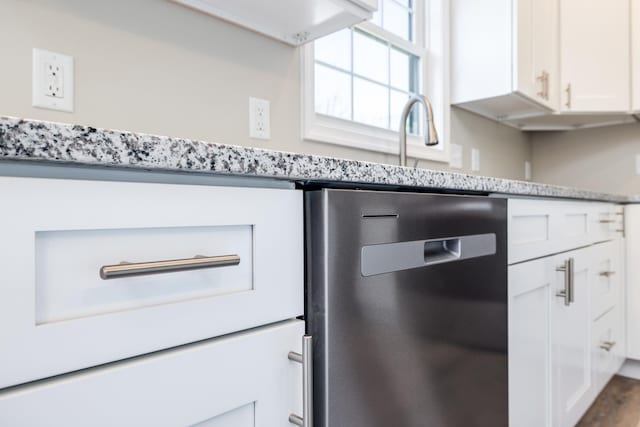 details featuring light stone countertops, dark wood-style flooring, white cabinetry, and dishwasher