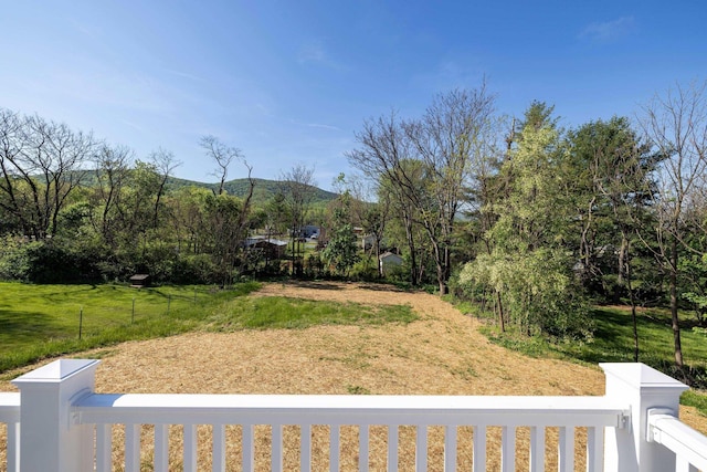 view of yard with a mountain view and fence