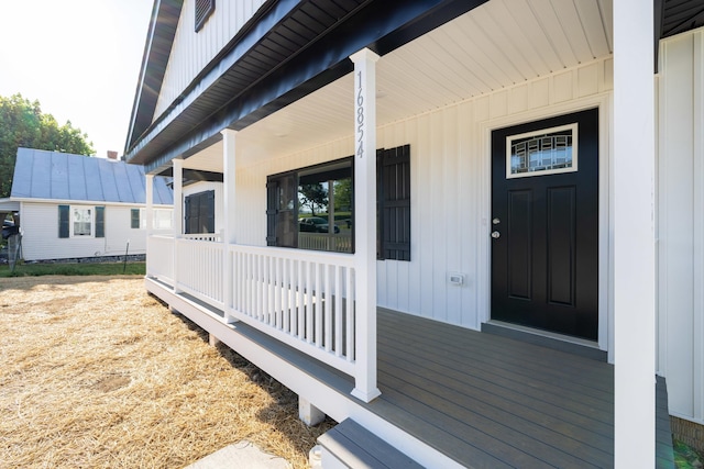 entrance to property featuring covered porch and board and batten siding