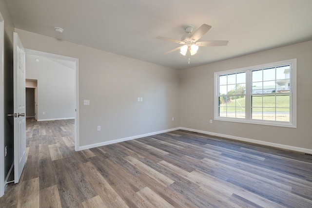 spare room featuring baseboards, ceiling fan, and wood finished floors