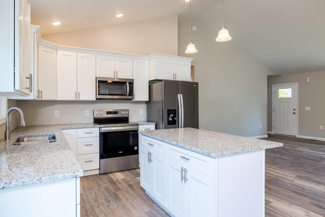 kitchen with a center island, a sink, white cabinets, light wood-style floors, and stainless steel appliances