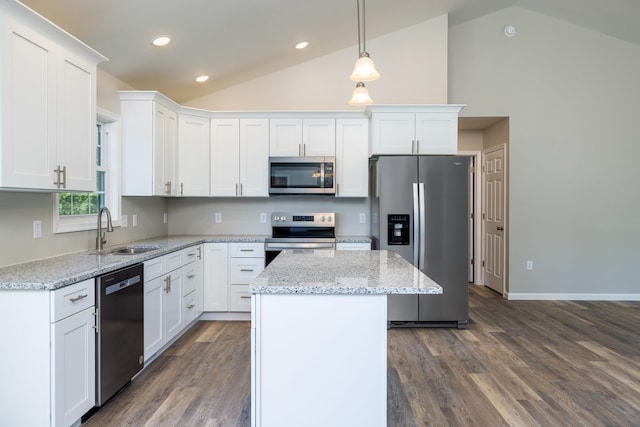 kitchen with a kitchen island, appliances with stainless steel finishes, a sink, dark wood-style floors, and white cabinetry