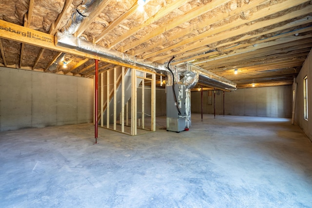 unfinished below grade area featuring heating unit