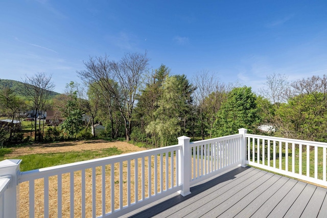 wooden terrace with a lawn