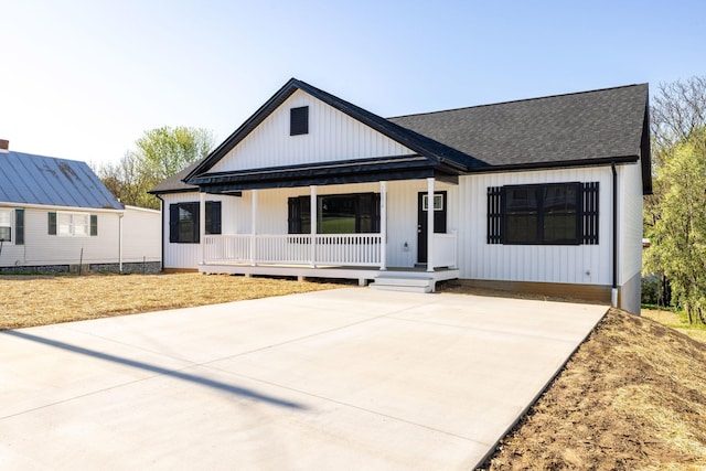 modern farmhouse featuring a porch and a shingled roof