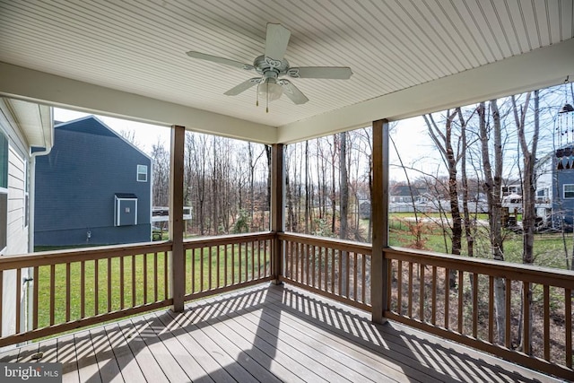 wooden terrace featuring a yard and ceiling fan