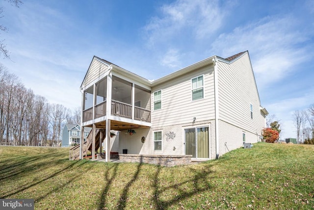 rear view of property featuring a patio area, stairway, a lawn, and a sunroom