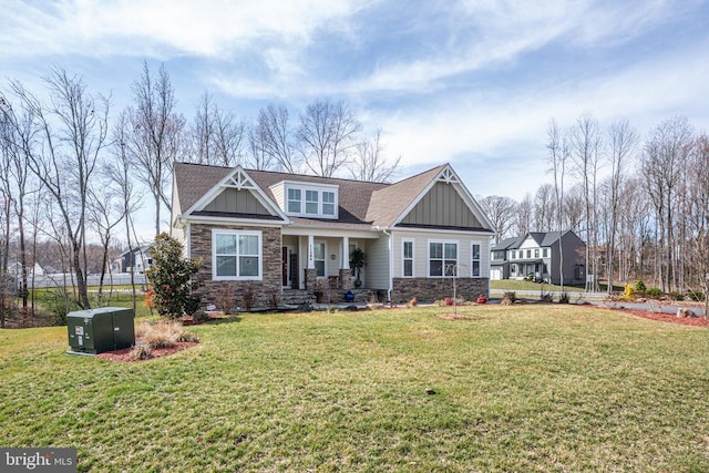 craftsman-style home with stone siding, board and batten siding, and a front yard