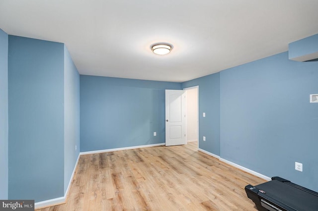 spare room featuring wood finished floors and baseboards