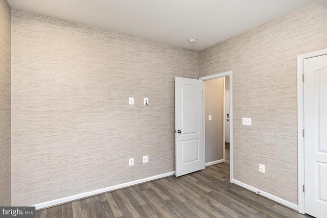 unfurnished bedroom featuring dark wood-style floors and baseboards