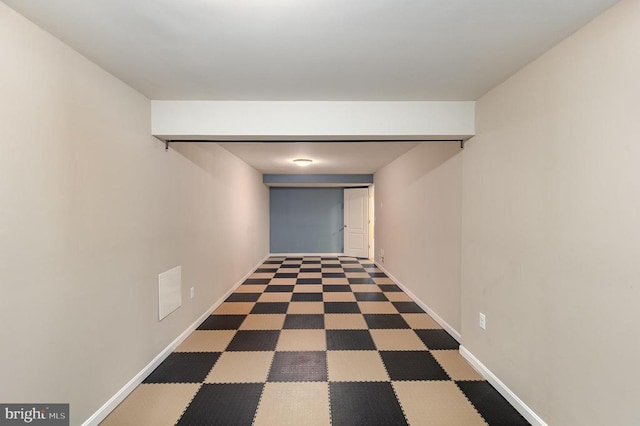 corridor with tile patterned floors and baseboards