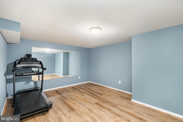 workout area with wood finished floors and baseboards