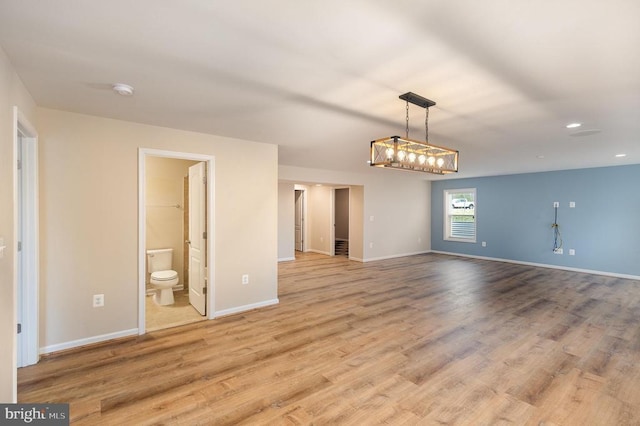 spare room with recessed lighting, baseboards, and wood finished floors