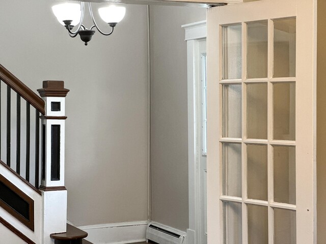 interior space with an inviting chandelier and a baseboard heating unit