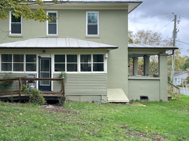 back of house with a lawn