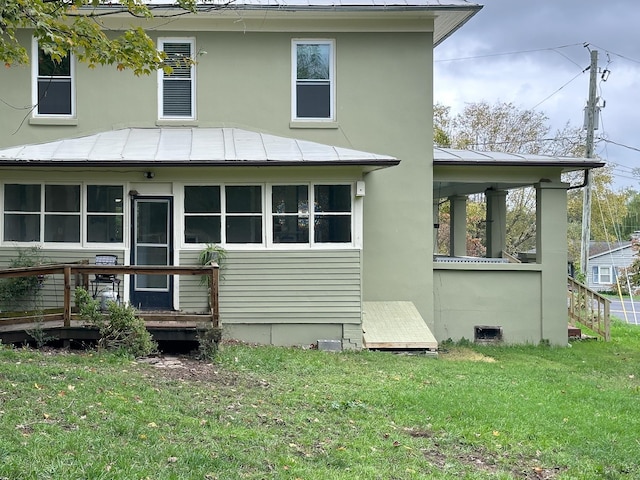 back of house with a lawn