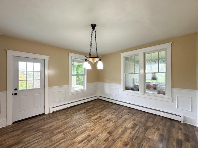 unfurnished dining area with baseboard heating, dark hardwood / wood-style flooring, and a notable chandelier