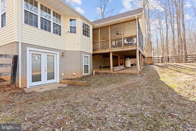 rear view of property featuring ceiling fan and french doors