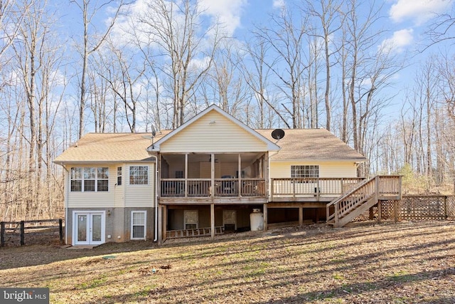 back of house featuring french doors, a deck, and a sunroom