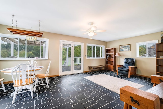 living room featuring plenty of natural light, ceiling fan, and french doors