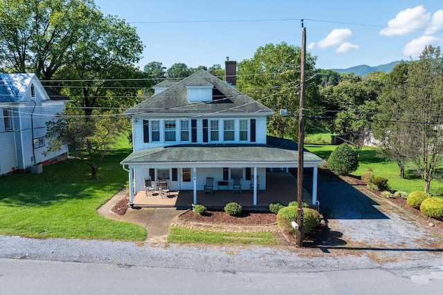 view of front facade featuring a front yard and covered porch