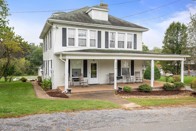 view of front facade featuring a front yard and covered porch