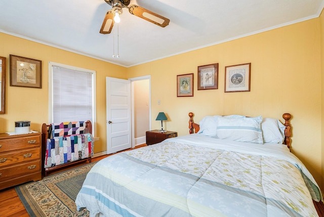 bedroom featuring crown molding, hardwood / wood-style floors, and ceiling fan