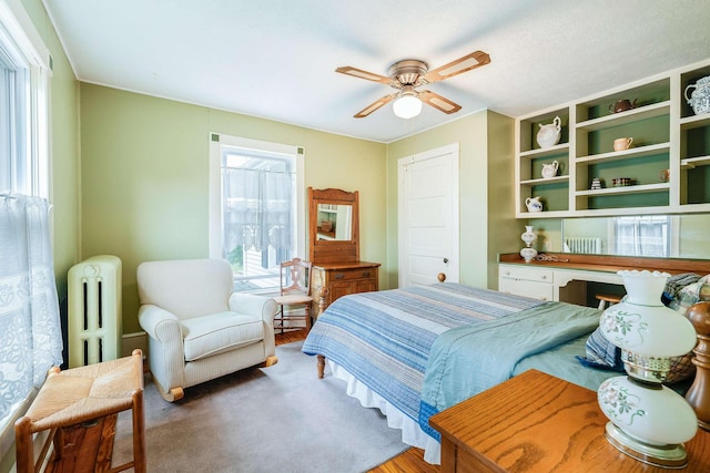 bedroom with ceiling fan and radiator